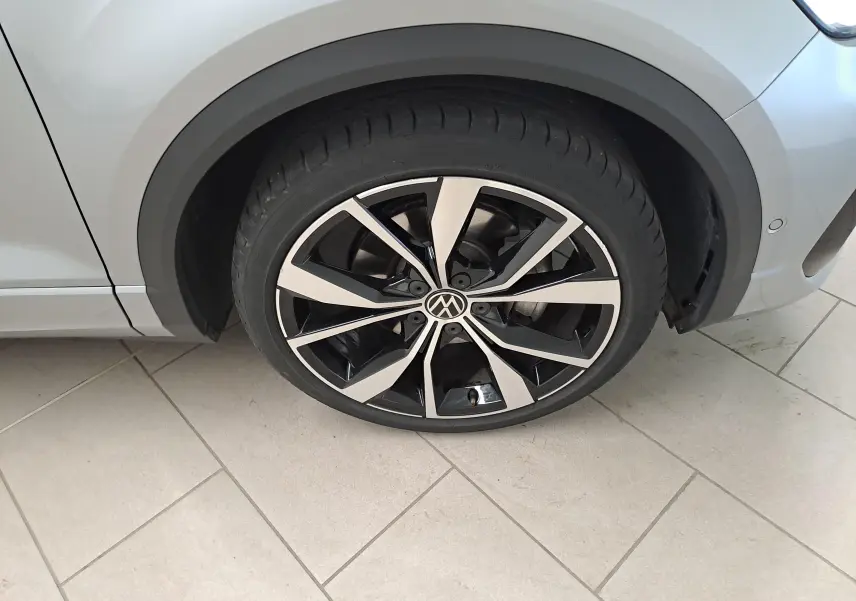 Gros plan sur la jante noire et argentée 19'' Misano du côté avant droit du Volkswagen T-Roc gris pyrite.