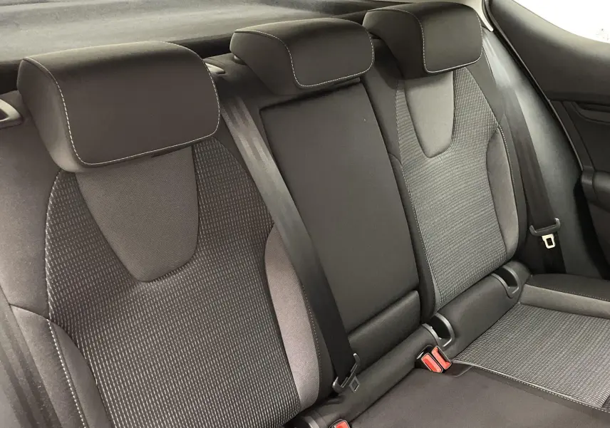 Vue rapprochée des sièges arrière noirs et gris de la Skoda Octavia 2024, finition Selection, avec ceintures visibles.