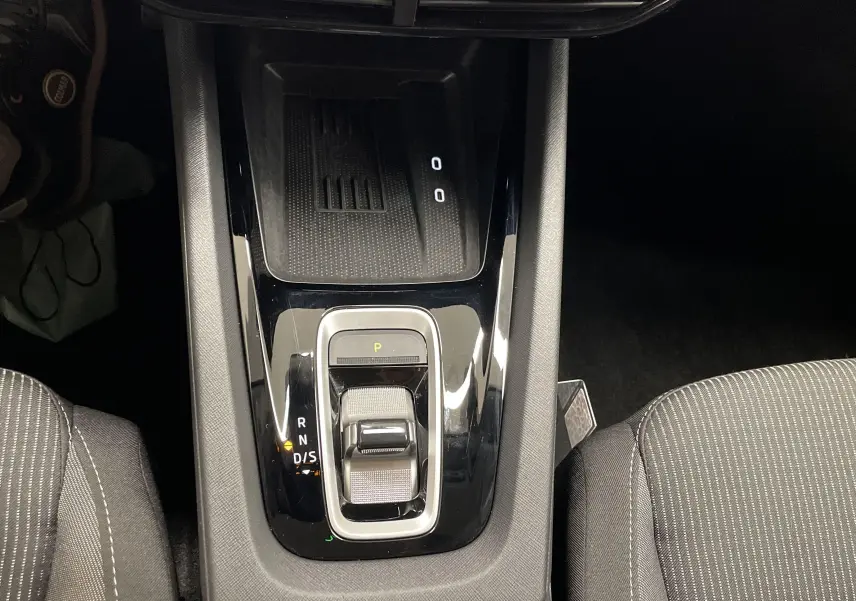Vue plongeante sur la console centrale noire brillante de la Skoda Octavia 2024, avec levier de boîte automatique DSG7.