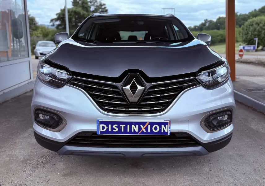 Vue frontale d'un Renault Kadjar gris avec capot noir et calandre noire brillante, plaque d'immatriculation Distinxion visible.