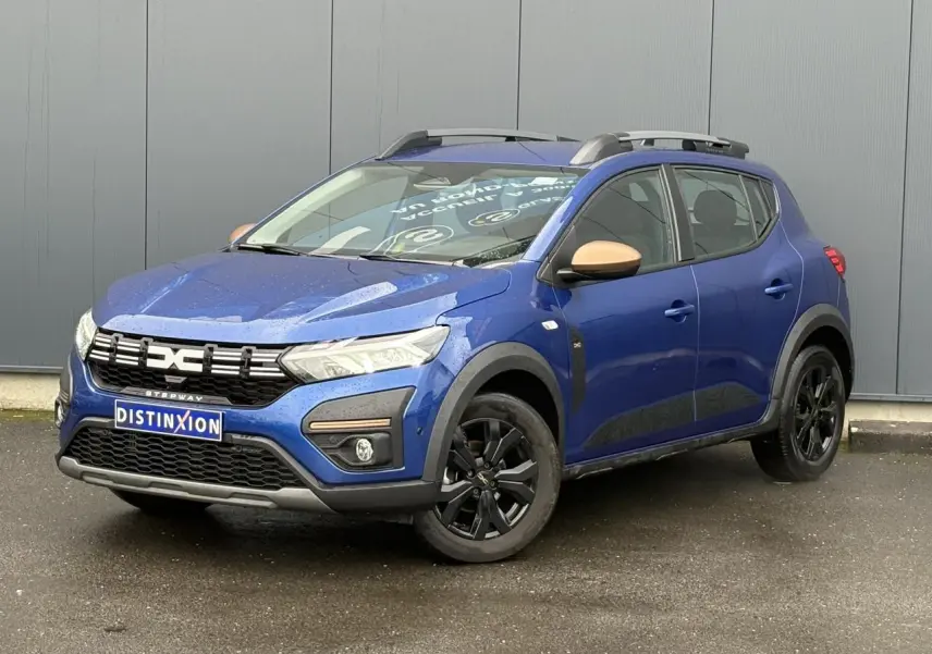 Dacia Sandero Stepway Bleu Iron en 3/4 avant droit avec jantes noires et coques de rétroviseurs cuivrées.