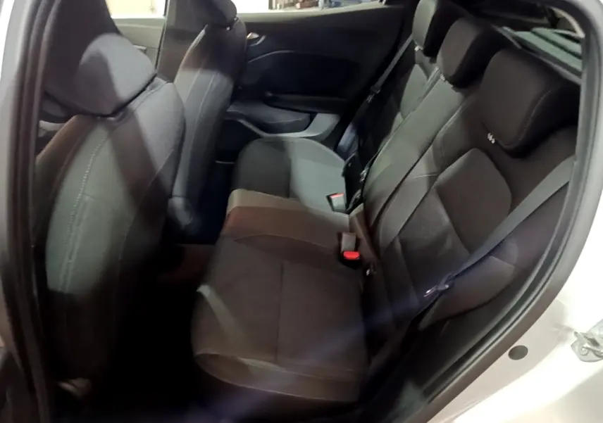 Vue intérieure côté droit montrant la banquette arrière noire d'une Renault Clio 2023 gris clair avec ceinture de sécurité.