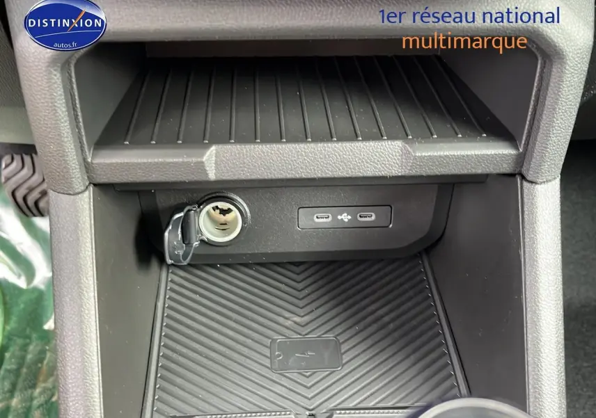 Dacia Duster 2025 gris schiste, vue rapprochée de la console centrale avec prise 12V et ports USB.