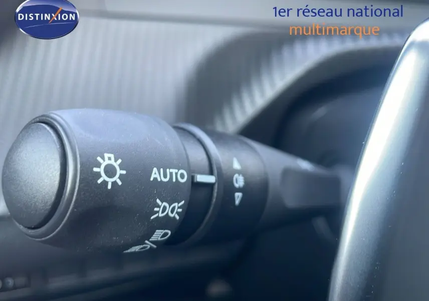 Gros plan sur la commande des phares du Peugeot 2008 gris Artense, mettant en valeur les réglages automatiques.