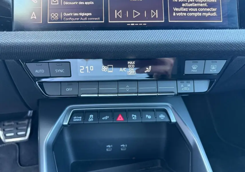 Vue rapprochée de la console centrale de l'Audi A3 Sportback 2025, avec commandes climatisation et boutons multifonctions.