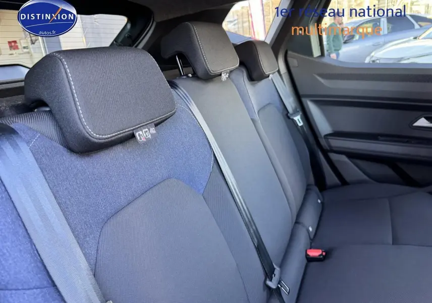 Vue intérieure du siège arrière côté droit du Dacia Duster 2025, tissu noir et bleu, avec ceintures de sécurité visibles.