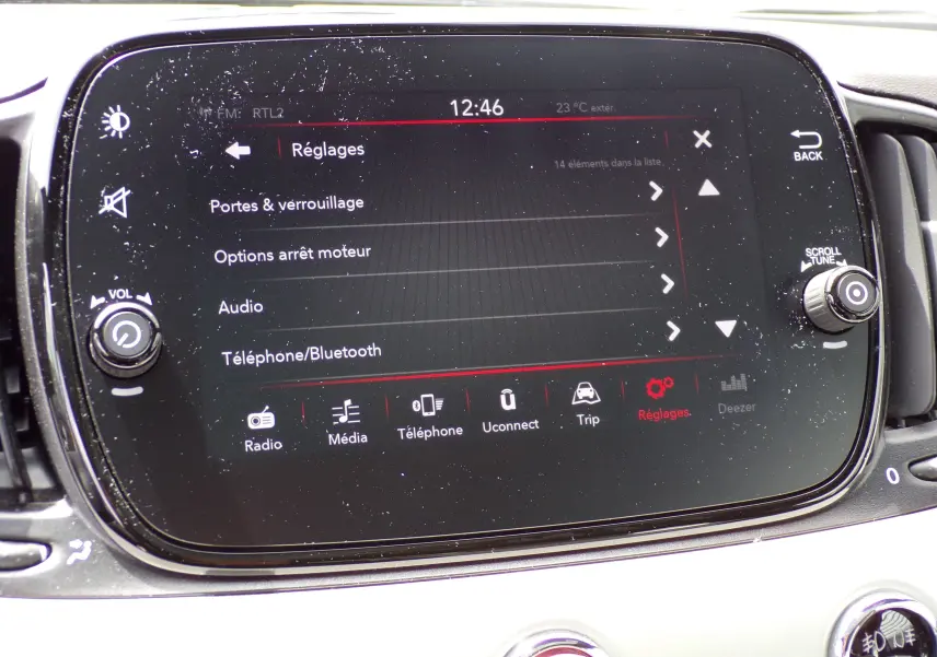 Écran tactile central de la Fiat 500 blanc 2019 affichant le menu réglages avec options audio et Bluetooth.