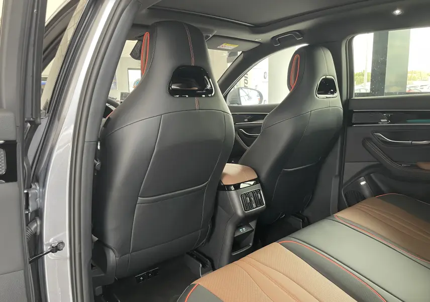 Vue arrière intérieure côté gauche du BYD SEAL U 2025 en Time Grey, sièges noirs et marron avec surpiqûres rouges.