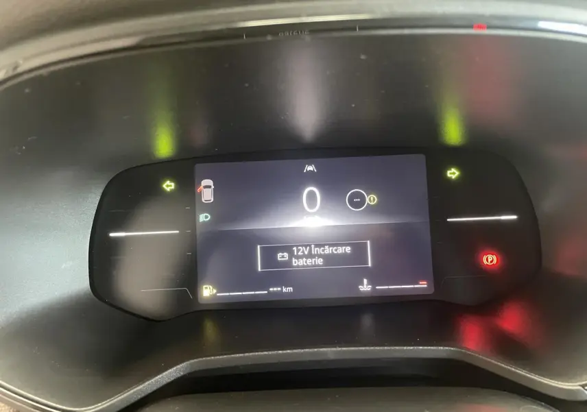 Affichage numérique du tableau de bord Renault Clio 2025 avec indication 12V batterie et voyants allumés.