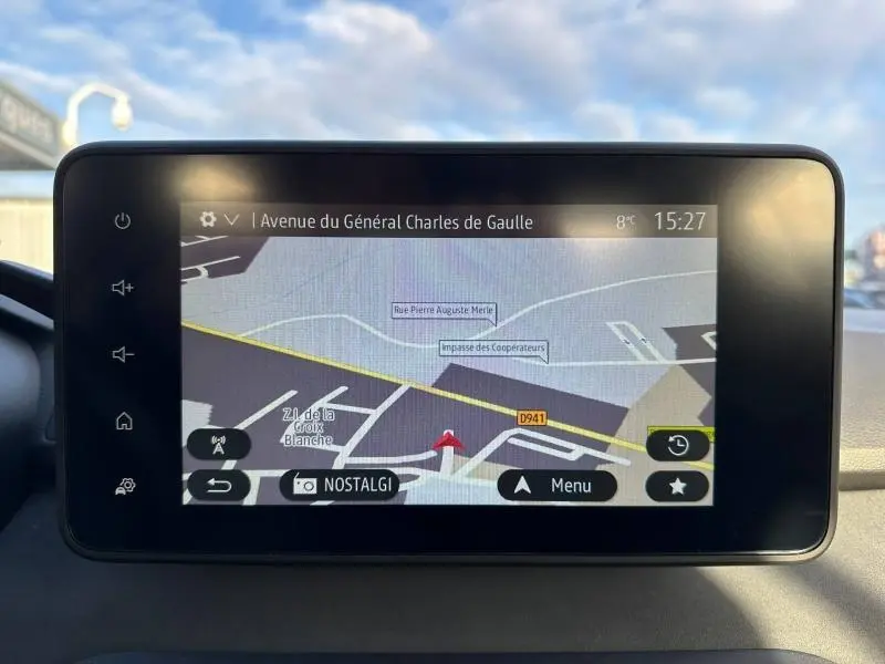 Écran tactile du système de navigation de la Dacia Sandero 2025 affichant une carte avec itinéraire en cours.