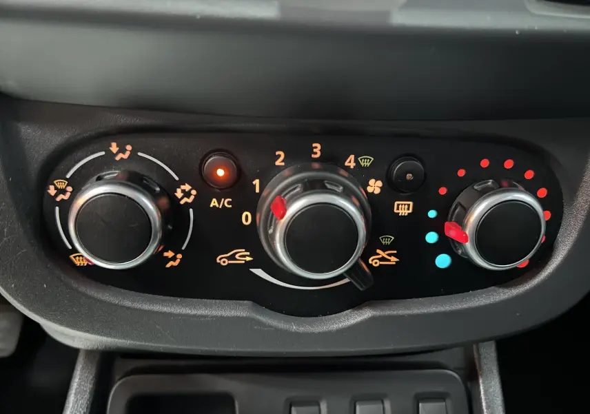 Panneau de commande de climatisation du Dacia Duster gris 2017, avec réglages manuels et témoin A/C allumé.