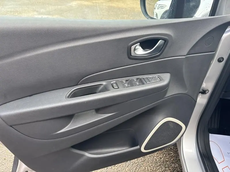 Vue intérieure côté gauche de la porte avant gris platine du Renault Captur 2019 avec commandes de vitres et haut-parleur intégré.