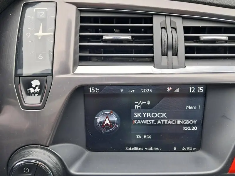 Tableau de bord de Citroën DS5 gris foncé, vue rapprochée sur écran multimédia et horloge analogique intégrée.