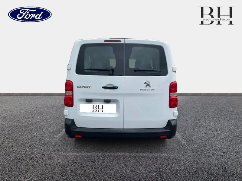 Vue arrière d'un Peugeot Expert Fourgon blanc Banquise avec portes battantes et feux rouges verticaux.