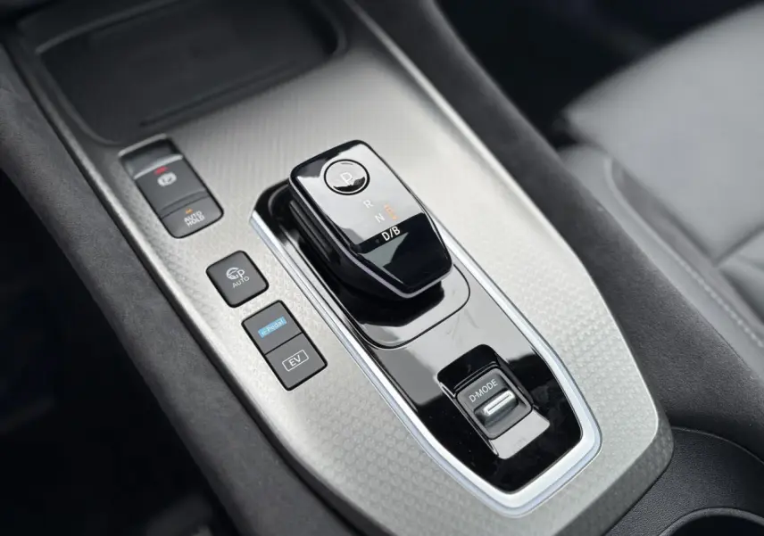 Gros plan sur la console centrale du Nissan Qashqai 2025 avec levier de vitesses automatique et boutons e-Pedal et D-Mode.
