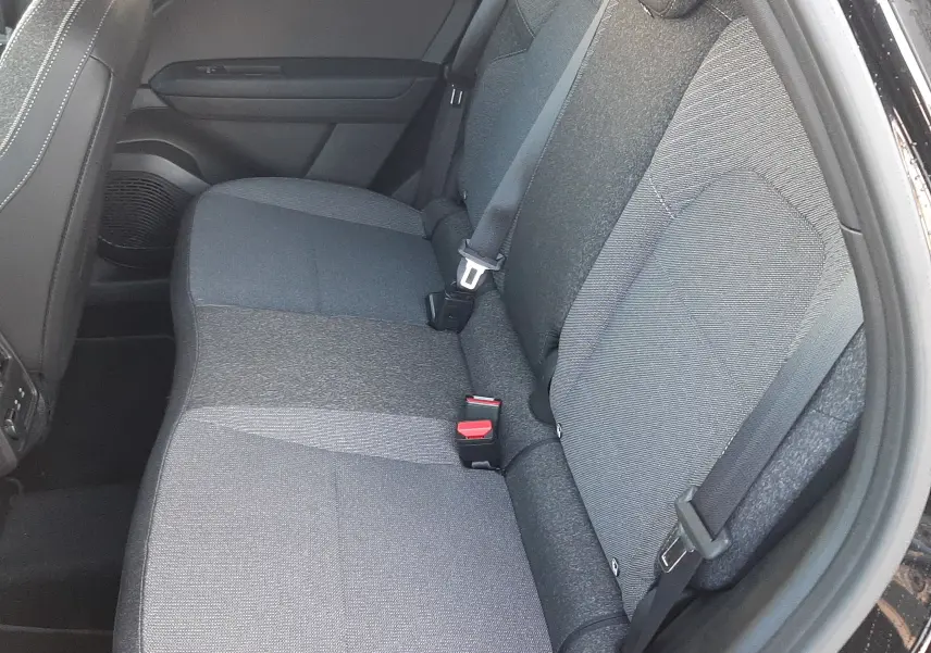 Vue latérale droite de la banquette arrière grise du Renault Captur 2024 noir métal avec ceintures de sécurité visibles.