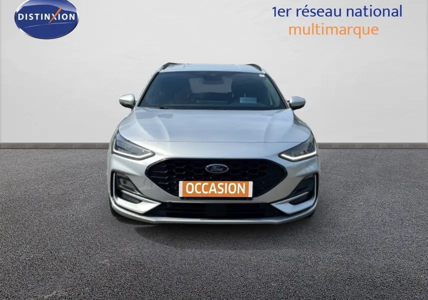 Vue frontale d'une Ford Focus SW 1.0 EcoBoost MHEV 125ch ST-Line X gris lunaire métal avec calandre noire et feux LED.