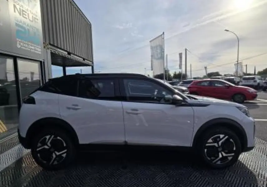 Profil droit du Peugeot 2008 hybride blanc Okenite avec toit noir et jantes alliage bi-ton 17 pouces.