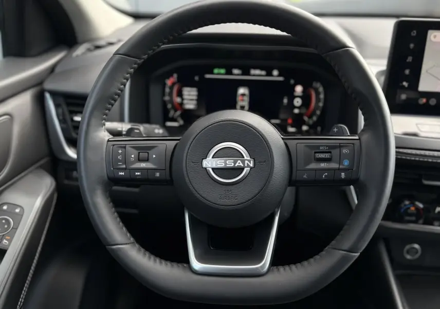 Volant cuir noir Nissan Qashqai 2025 vu de face avec commandes intégrées et tableau de bord numérique.