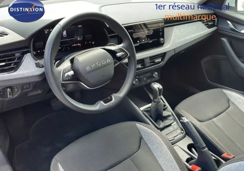 Intérieur de la Skoda Scala blanc glacier, vue côté conducteur sur le volant multifonction et la console centrale.