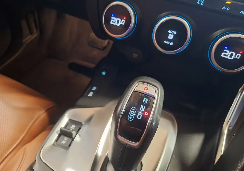 Le levier de vitesses automatique noir et argenté du Jaguar E-PACE 2019, avec commandes climatisation à 20°C en arrière-plan.