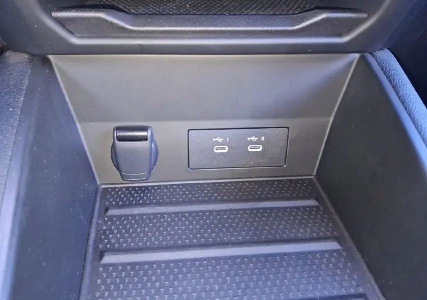 Gros plan sur la console centrale noire du Renault Symbioz 2025 montrant deux ports USB-C et une prise 12V.