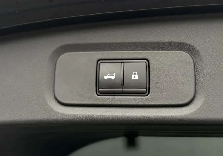 Gros plan sur les boutons d'ouverture et de verrouillage du hayon électrique du Nissan Qashqai gris Squale.