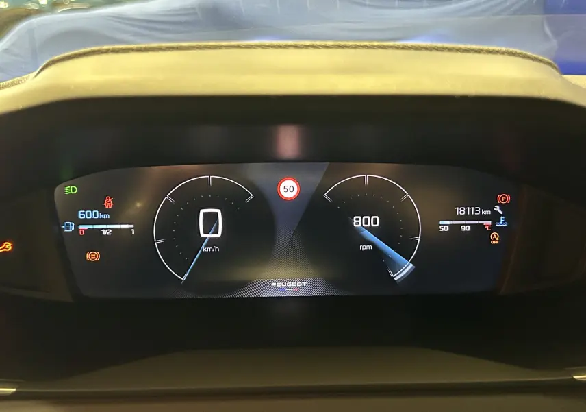 Tableau de bord numérique du Peugeot 208 Turbo 100 BVM6 Allure, affichant vitesse, régime et alertes.