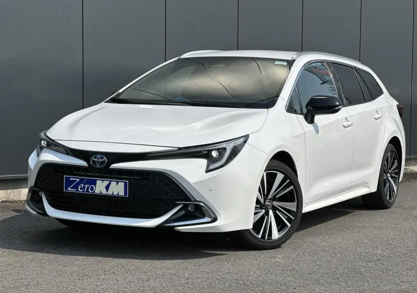 Toyota Corolla Touring Sport blanc Neige en 3/4 avant droit avec jantes alliage 17'' et vitres teintées.