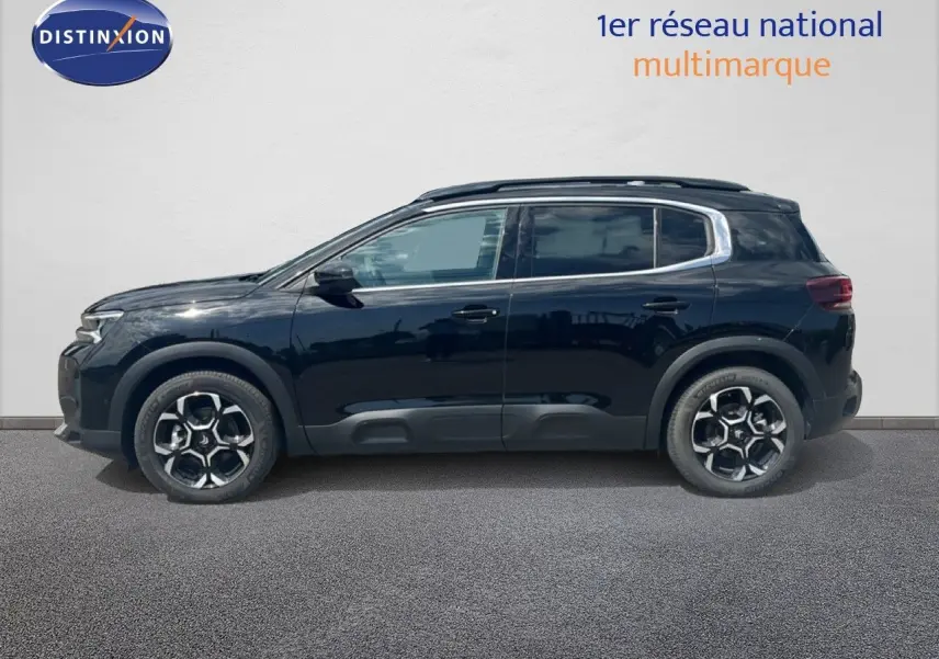 Profil côté gauche du Citroën C5 Aircross noir métal 2025, SUV hybride avec jantes bicolores distinctives.