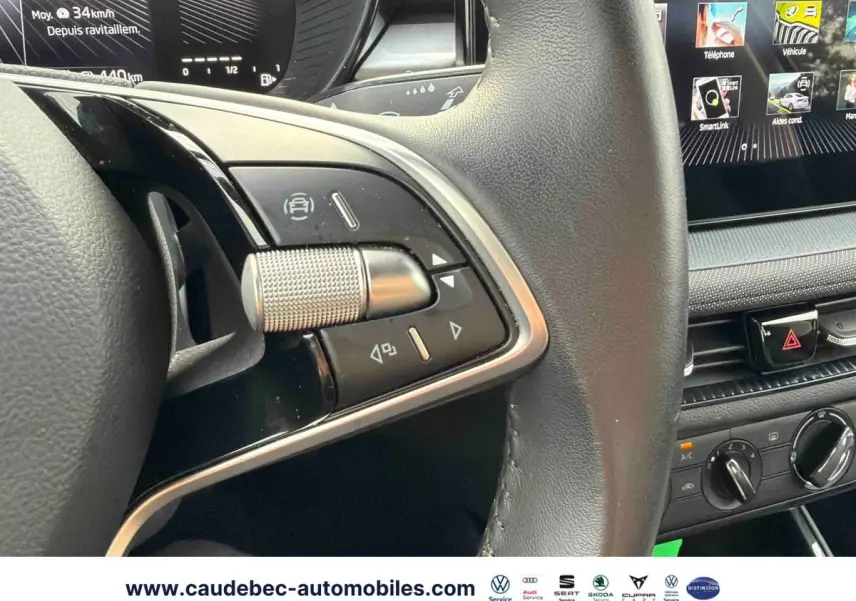 Gros plan sur le volant cuir noir multifonctions et la partie centrale de la planche de bord avec écran tactile de la Skoda Fabia 2025.