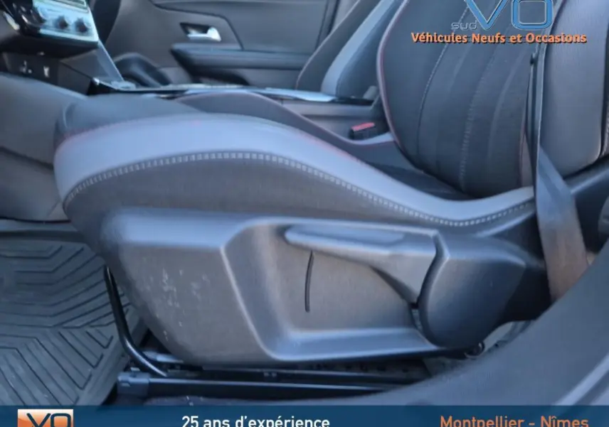 Gros plan sur le siège conducteur noir avec surpiqûres rouges de l'Opel Mokka gris clair 2022 finition GS Line.