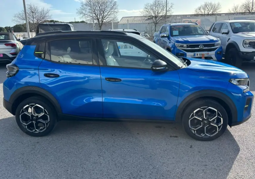 Profil côté gauche d'une Citroën C3 Turbo 100 ch bleu 2025 avec jantes alliage noires et toit noir.