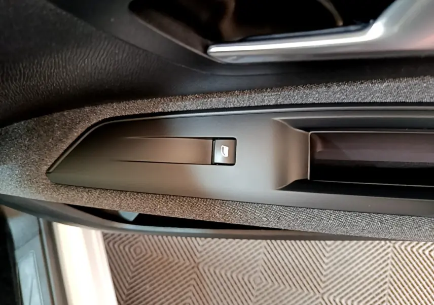 Détail de la commande de verrouillage sur la portière côté conducteur d'un Peugeot 3008 blanc 2020.