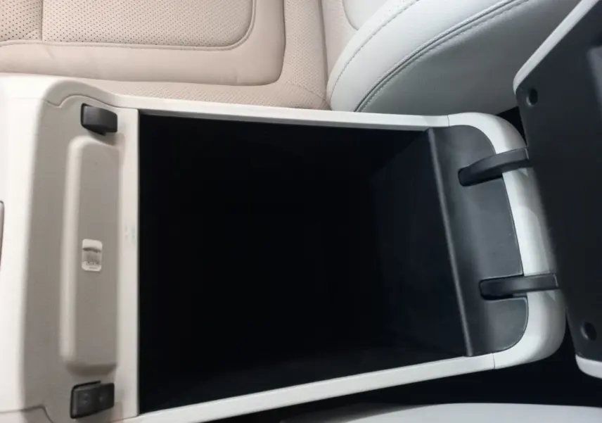 Gros plan sur le rangement central ouvert avec intérieur noir et sellerie cuir beige clair dans un Hyundai Tucson 2023.