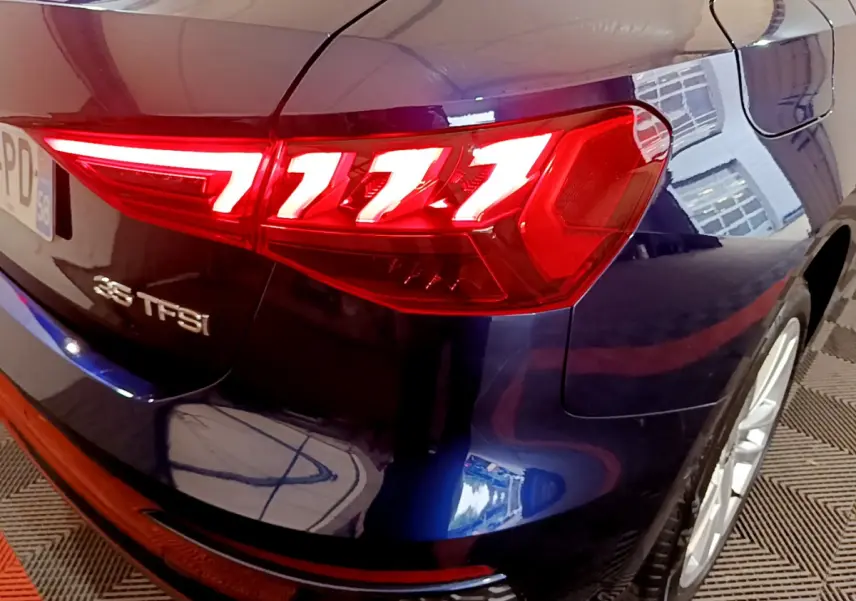 Gros plan sur le feu arrière droit rouge et la partie arrière bleue brillante d'une Audi A3 35 TFSI 2023.