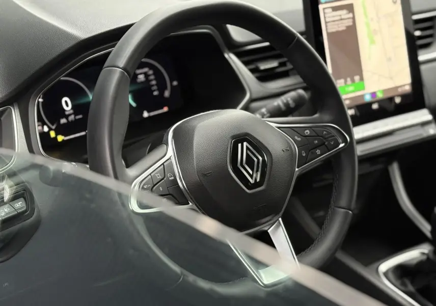 Vue rapprochée du volant noir du Renault Captur 2025 avec tableau de bord numérique et écran tactile GPS.