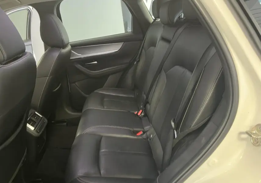 Vue intérieure côté droit des sièges arrière en cuir noir avec surpiqûres bronze du Mazda CX-60 blanc 2023 Homura.