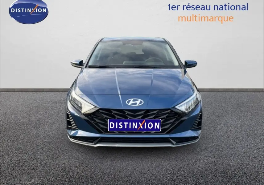 Vue frontale d'une Hyundai i20 1.0 TGDI 100CH KLASS bleu vibrant métal avec calandre noire et phares LED allumés.