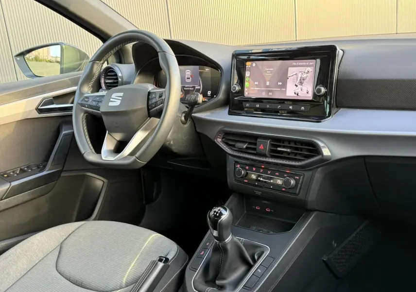 Vue intérieure côté conducteur de la SEAT Ibiza TSI 115 Xcellence 2025, avec tableau de bord moderne et volant cuir multifonction.