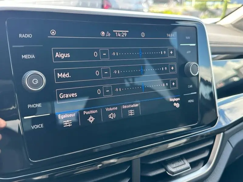 Écran tactile central du Volkswagen T-Roc 2025 montrant les réglages de l'égaliseur audio en intérieur noir brillant