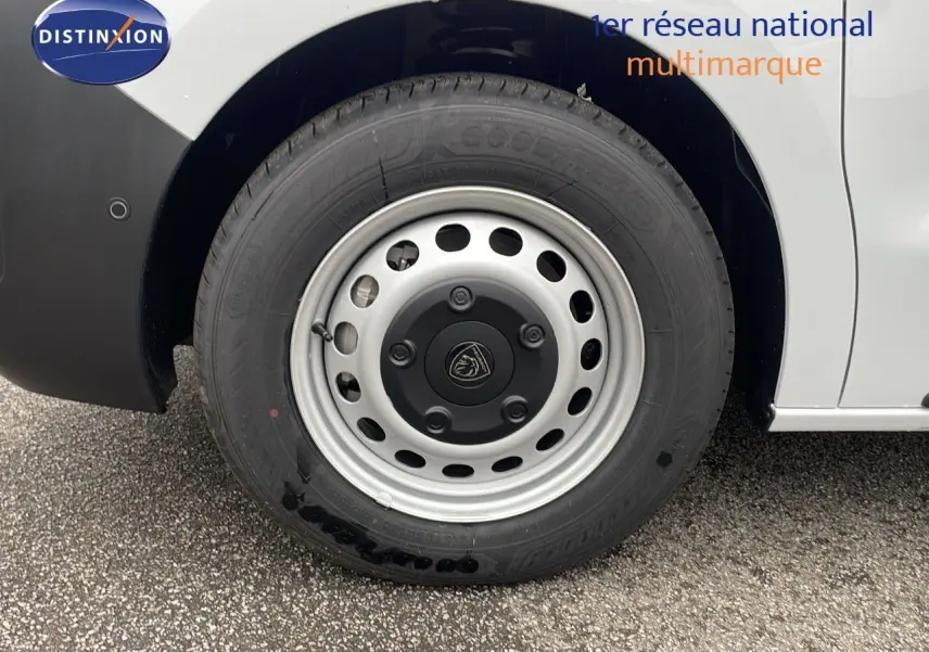 Gros plan sur la roue avant droite du Peugeot Expert Fourgon blanc 2025, mettant en valeur la jante acier et le logo Peugeot.