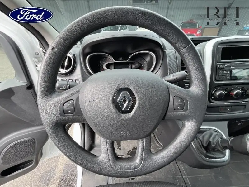 Vue intérieure centrée sur le volant noir du Renault Trafic Fourgon 2020 avec tableau de bord et levier de vitesse visibles.