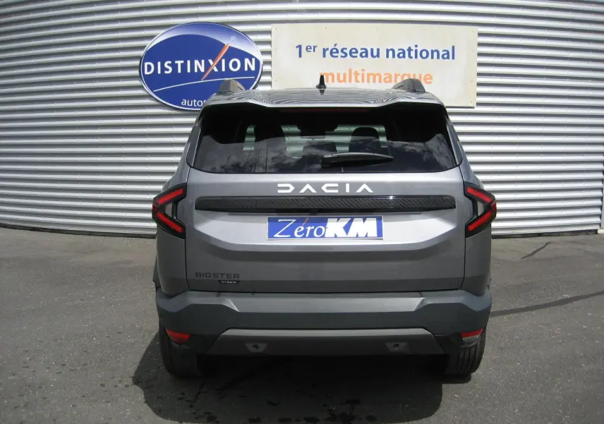 Vue arrière d'un Dacia Bigster gris schiste 2026 avec feux LED en forme de C et logo distinctif bien visible.