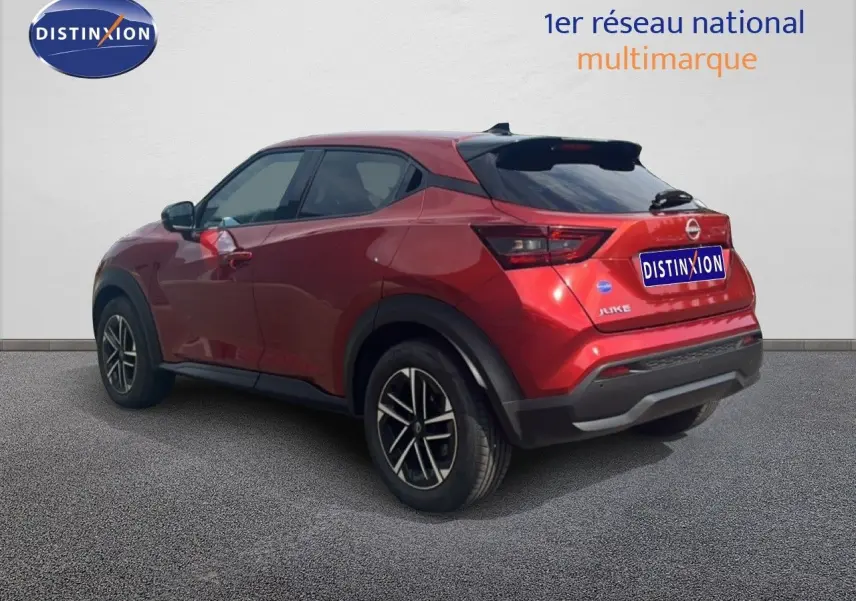 Nissan Juke rouge Fuji Metal en 3/4 arrière droit, avec jantes alliage et toit noir contrasté.