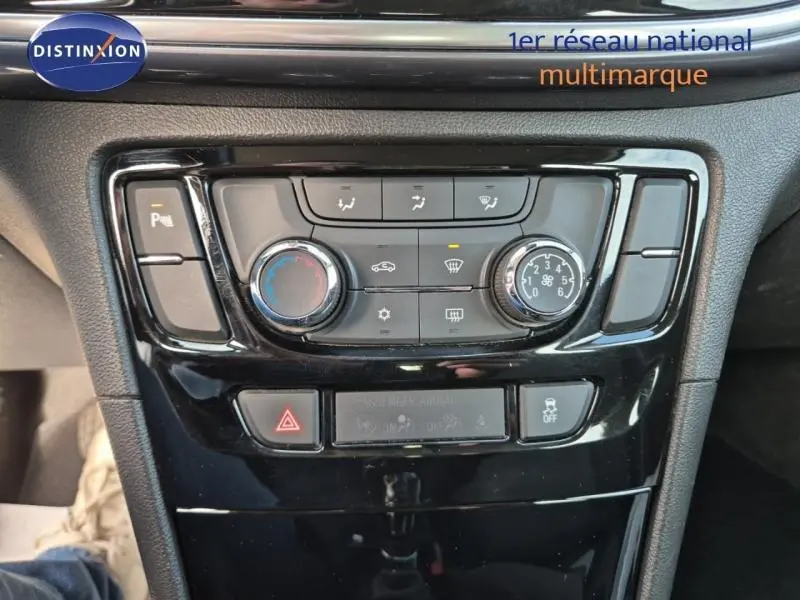 Vue rapprochée de la console centrale noire de l’Opel Mokka X 2018 avec commandes de climatisation et boutons multifonctions.