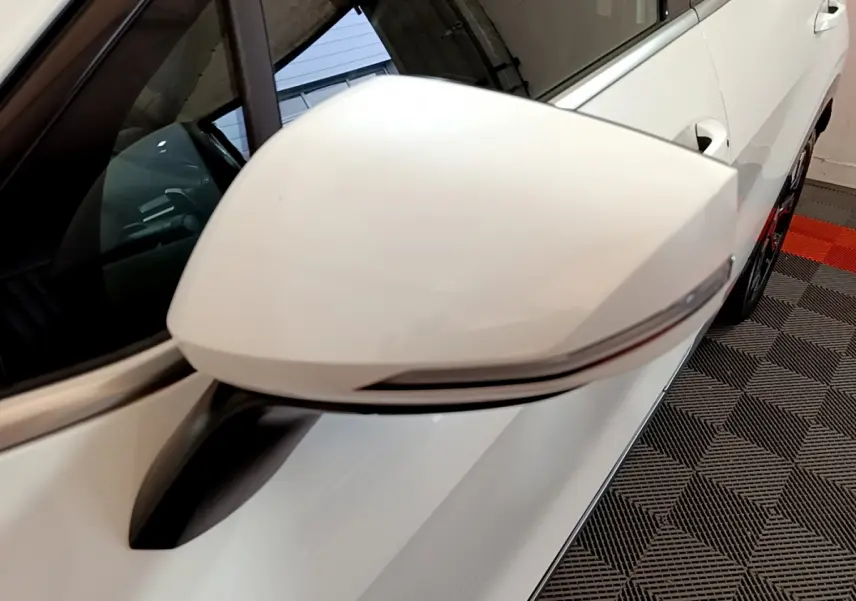 Rétroviseur blanc côté gauche du Kia Sportage 2022 hybride rechargeable, avec clignotant intégré, vue rapprochée.