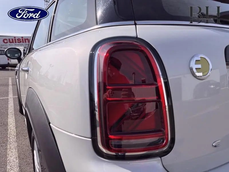 Gros plan sur le feu arrière droit d'une MINI Countryman Cooper SE Moonwalk Grey, avec logo électrique visible sur le hayon.