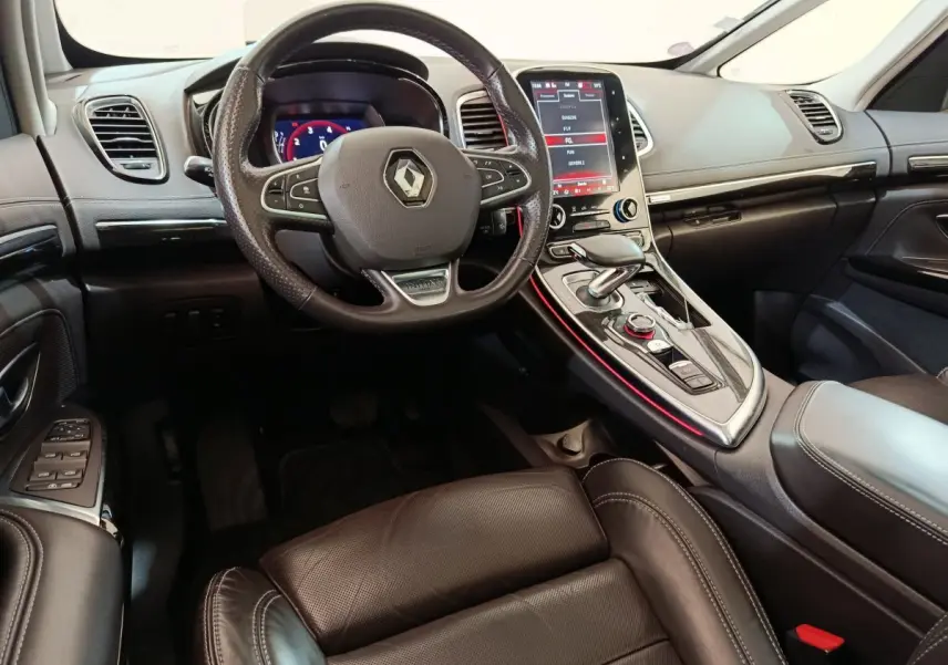 Intérieur noir du Renault Espace 2018 vu côté conducteur, volant cuir, écran tactile vertical et console centrale éclairée rouge.