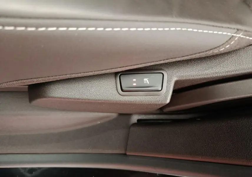 Gros plan sur le bouton de siège chauffant activé sous la sellerie cuir noire du Renault Espace Initiale Paris 2018